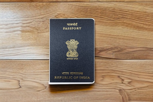 a indian passport sitting on top of a table，wooden, grained table