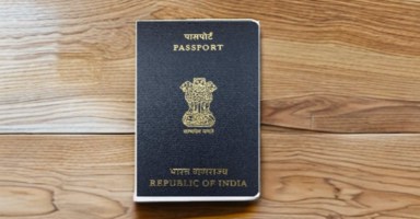 a indian passport sitting on top of a table